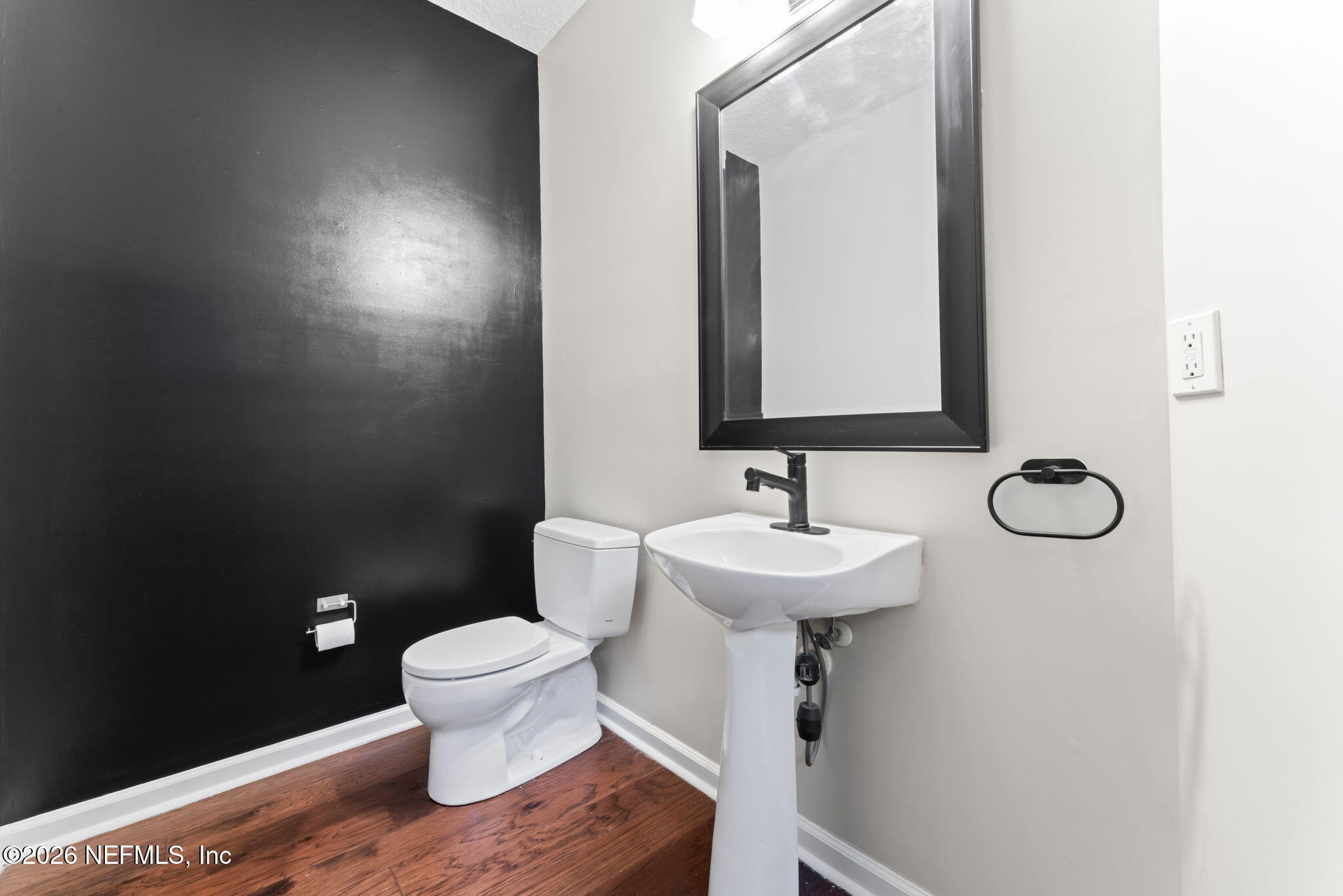 5663 Greenland Road, Unit 1201 Jacksonville, FL 32258 - Photo 10 of 82 a bathroom with a toilet sink and mirror