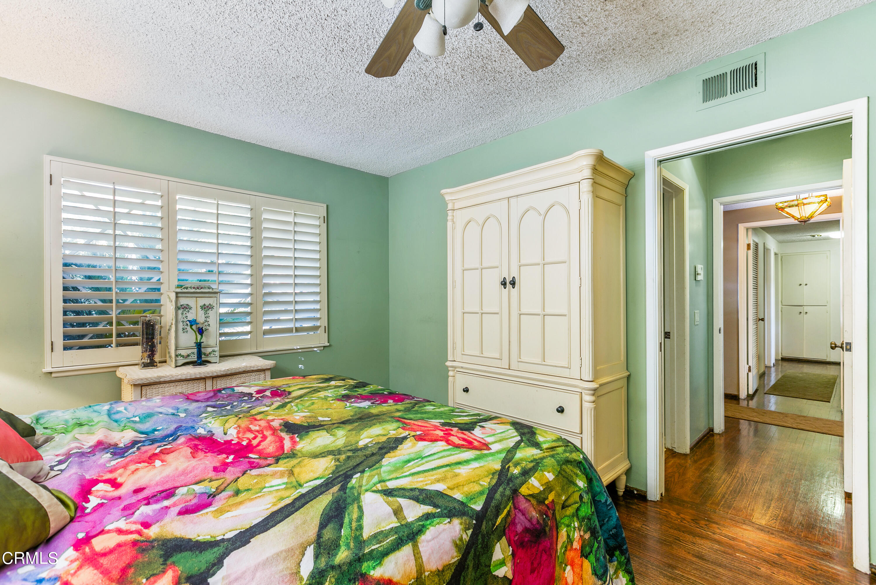 4131 Aralia Road Altadena, CA 91001 - Photo 8 of 19 a bedroom with a bed and a chandelier