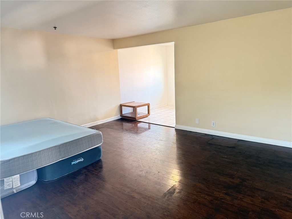 1330 Stevens Avenue, Unit E San Gabriel, CA 91776 - Photo 12 of 12 a room with a bed and wooden floor