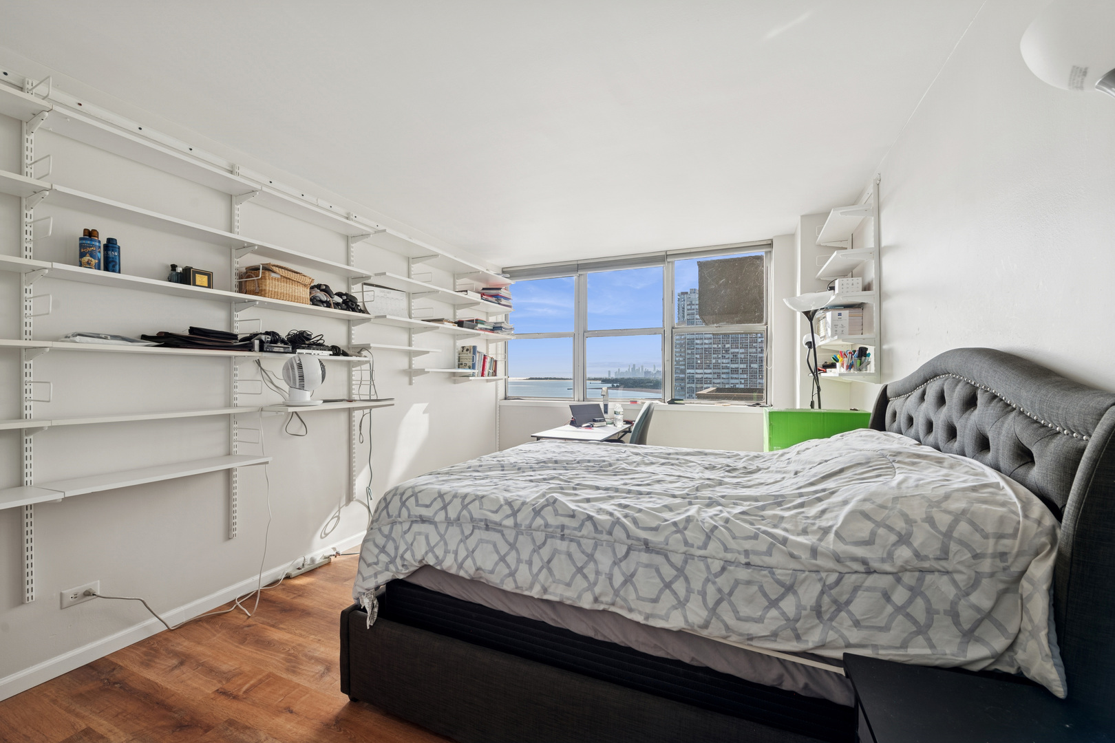 6301 North Sheridan Road, Unit 14E Chicago, IL 60660 - Photo 17 of 20 a bedroom with a bed and a cabinets