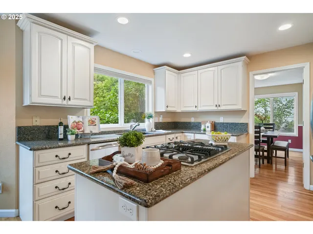 a kitchen with stainless steel appliances granite countertop a stove and cabinets