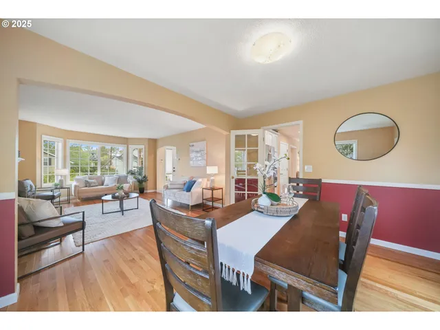 a living room with furniture a fireplace and a large window