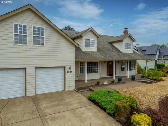 a front view of a house with sitting area and garden