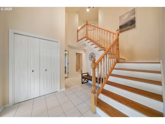 a living room with furniture a flat screen tv and floor to ceiling windows