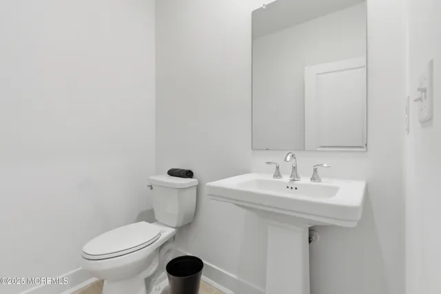 a white toilet sitting next to a bathroom sink