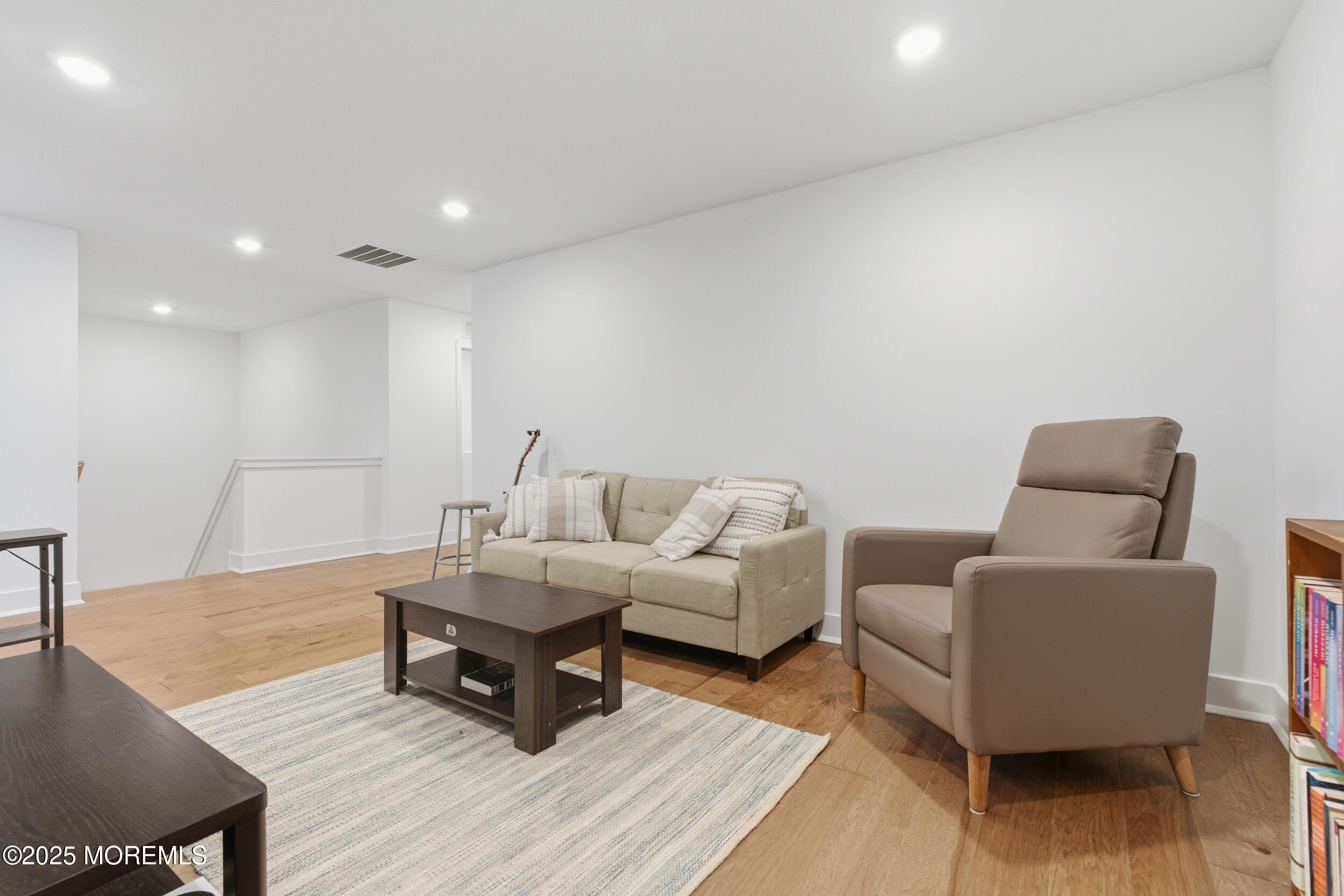 130 Woolley Court Oakhurst, NJ 07712 - Photo 15 of 34 a living room with furniture and a wooden floor