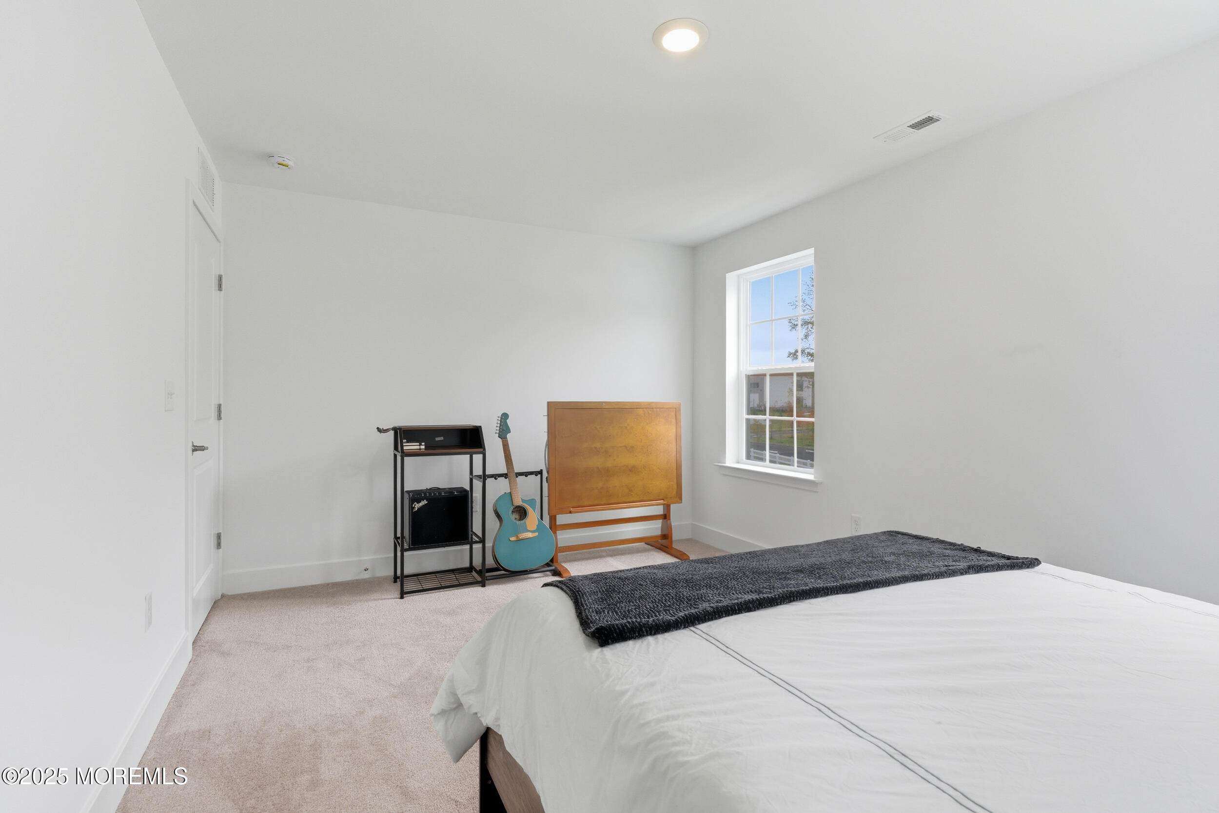 130 Woolley Court Oakhurst, NJ 07712 - Photo 19 of 34 a bedroom with a bed and a window