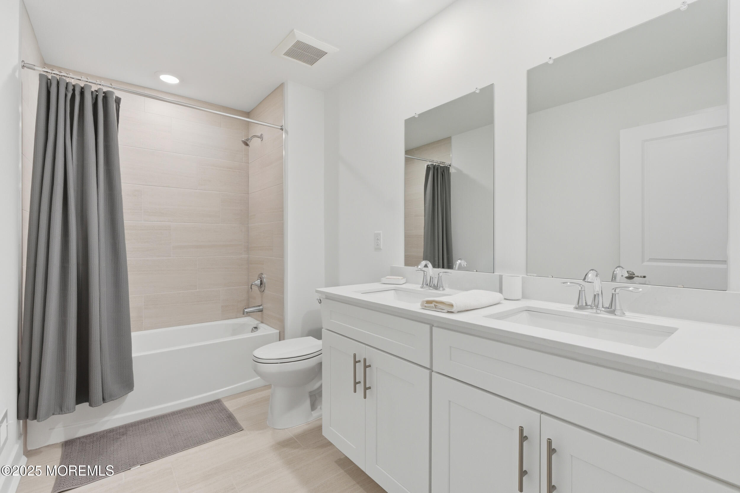 130 Woolley Court Oakhurst, NJ 07712 - Photo 20 of 34 a bathroom with a double vanity sink toilet mirror and bathtub