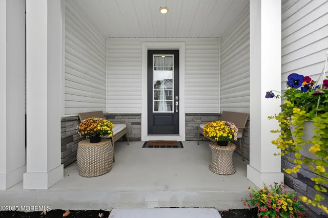 a front view of a house with outdoor seating