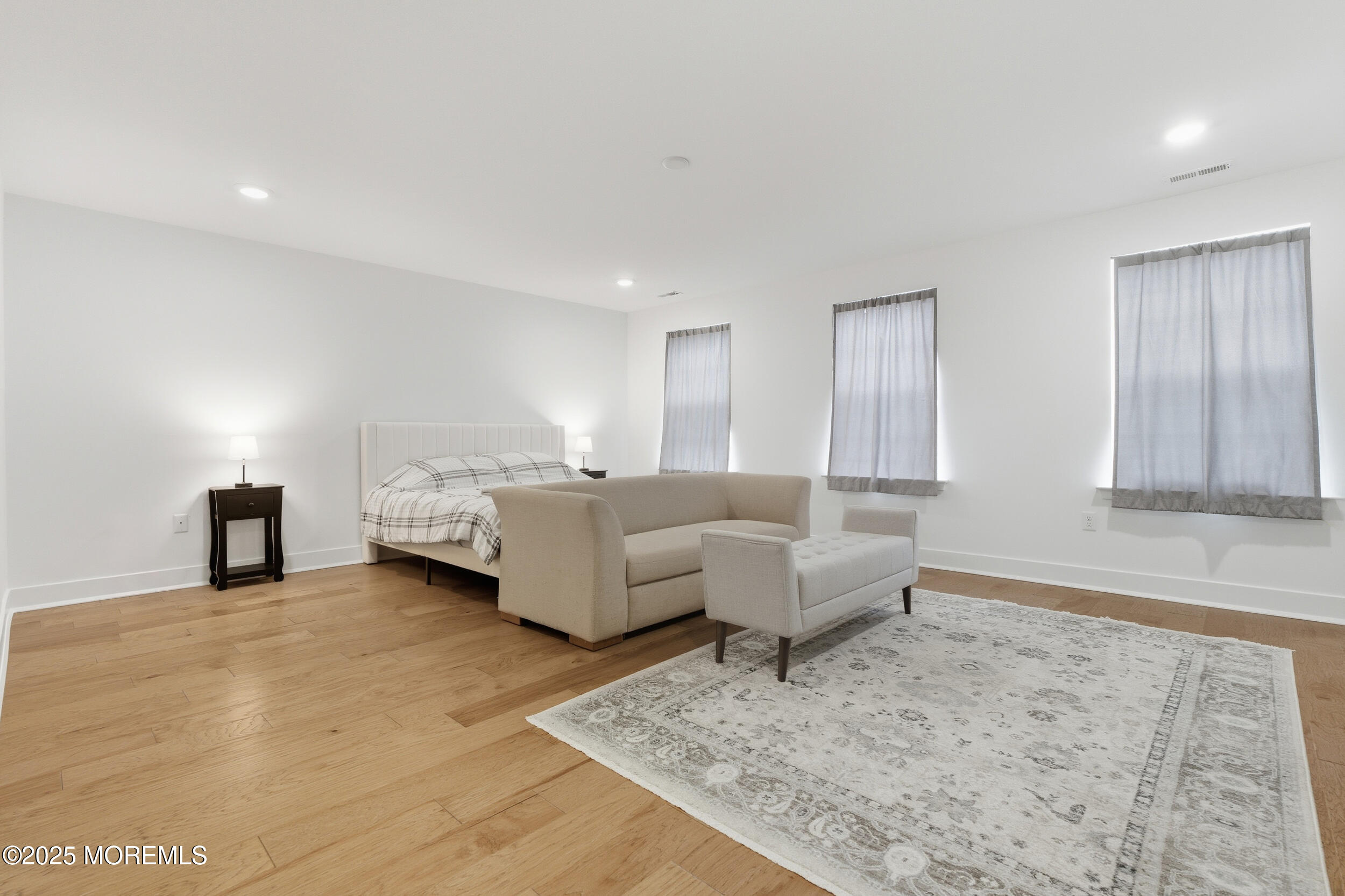 130 Woolley Court Oakhurst, NJ 07712 - Photo 22 of 34 a living room with couches and kitchen view with wooden floor
