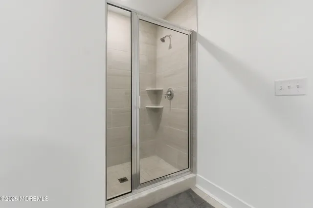 a bathroom with a glass shower door