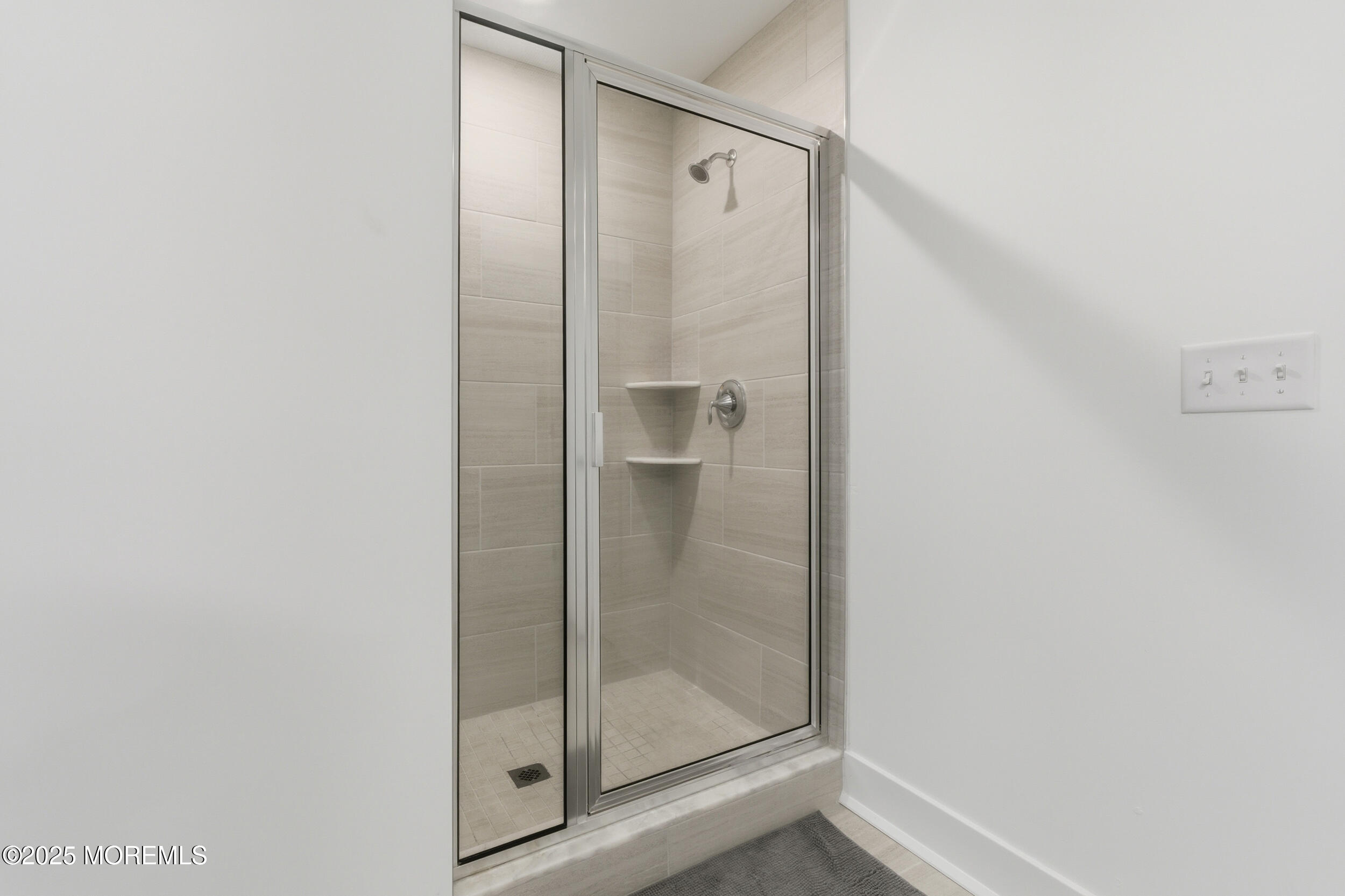 130 Woolley Court Oakhurst, NJ 07712 - Photo 26 of 34 a bathroom with a glass shower door
