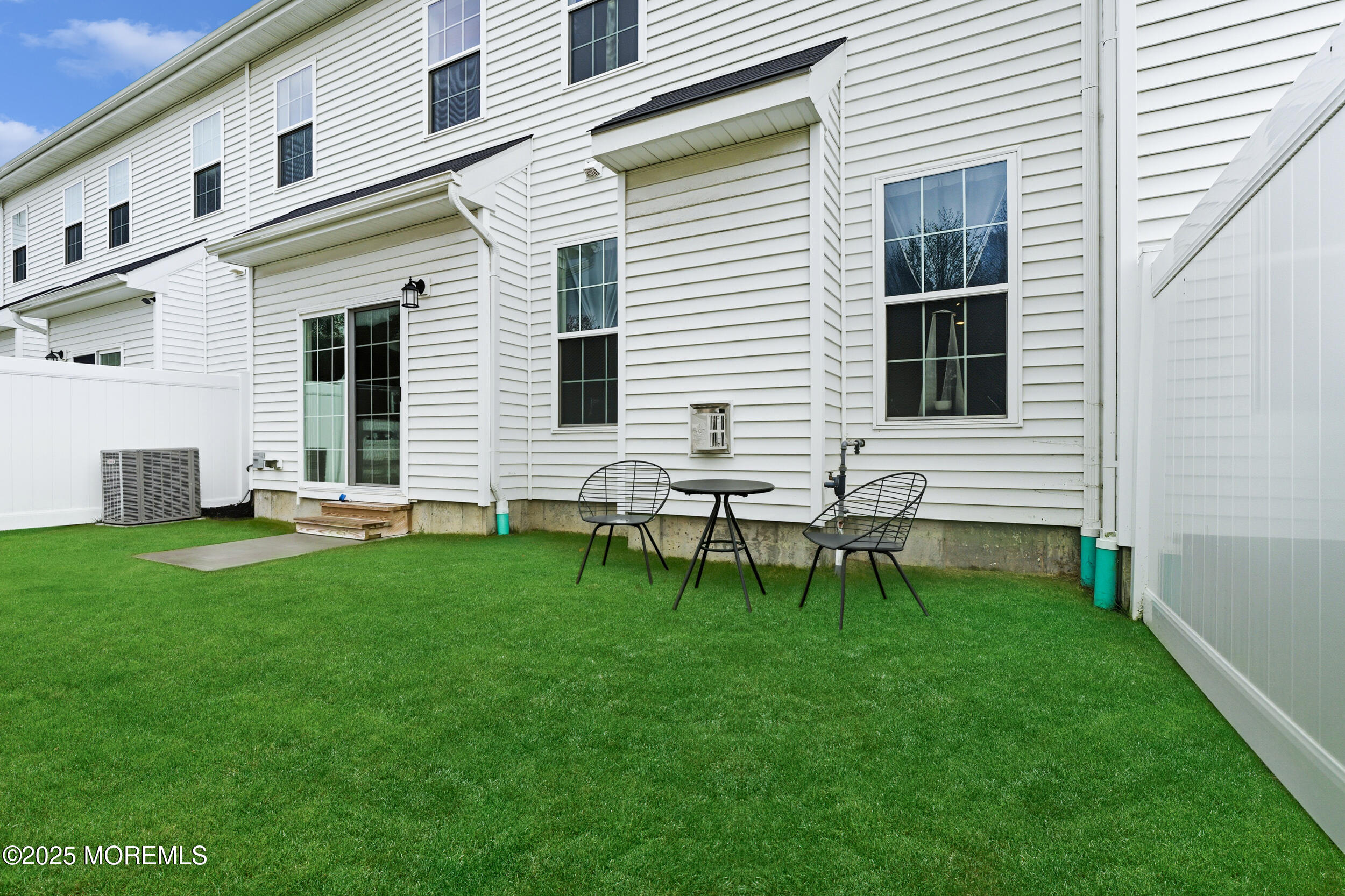 130 Woolley Court Oakhurst, NJ 07712 - Photo 30 of 34 a backyard of a house with table and chairs