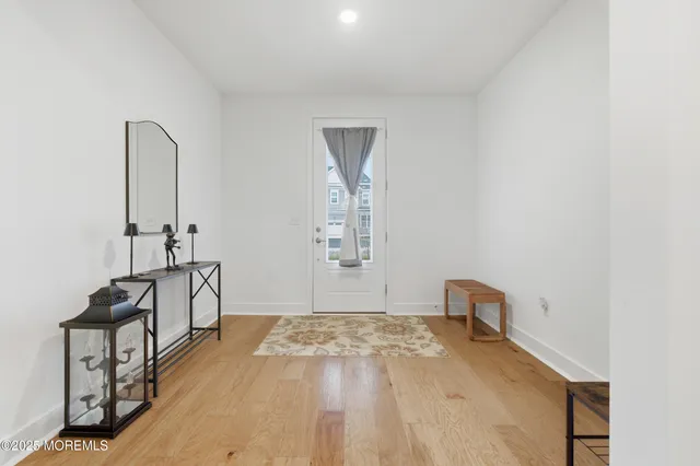 a view of a room with wooden floor