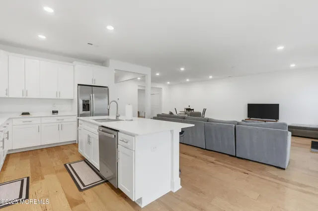 a kitchen with cabinets a sink and appliances