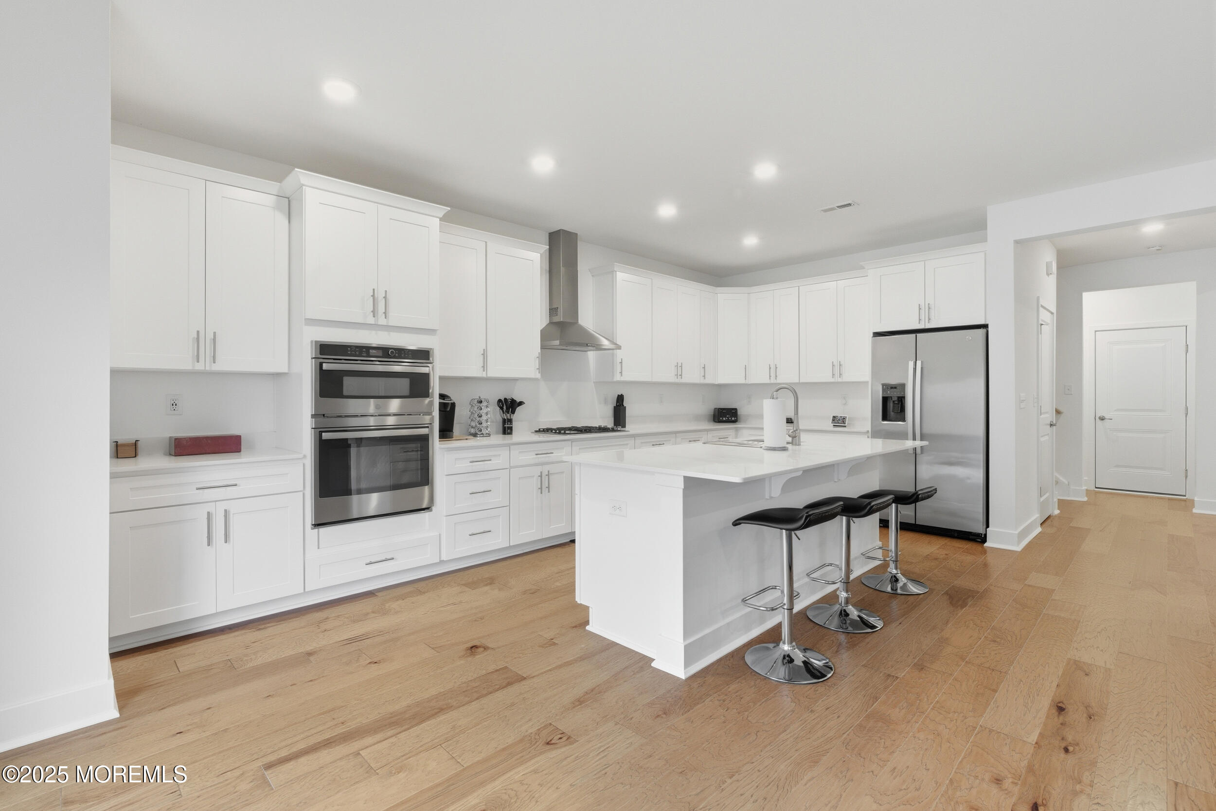 130 Woolley Court Oakhurst, NJ 07712 - Photo 9 of 34 a kitchen with white cabinets and stainless steel appliances