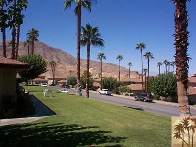 72685 Raven Road, Unit 3 Palm Desert, CA 92260 - Photo 1 of 8 a view of a swimming pool and a yard
