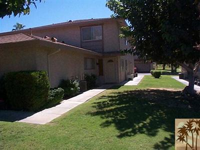 72685 Raven Road, Unit 3 Palm Desert, CA 92260 - Photo 2 of 8 a front view of a house with a yard