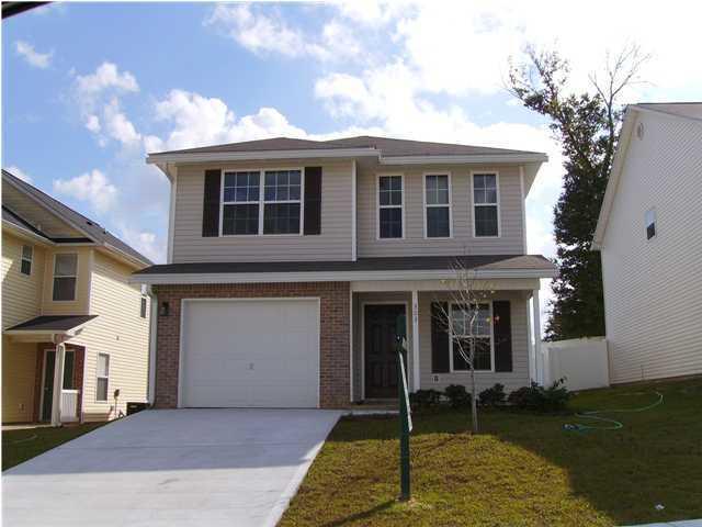 303 Dahlquist Drive Crestview, FL 32539 - Photo 1 of 15 a front view of a house with a yard