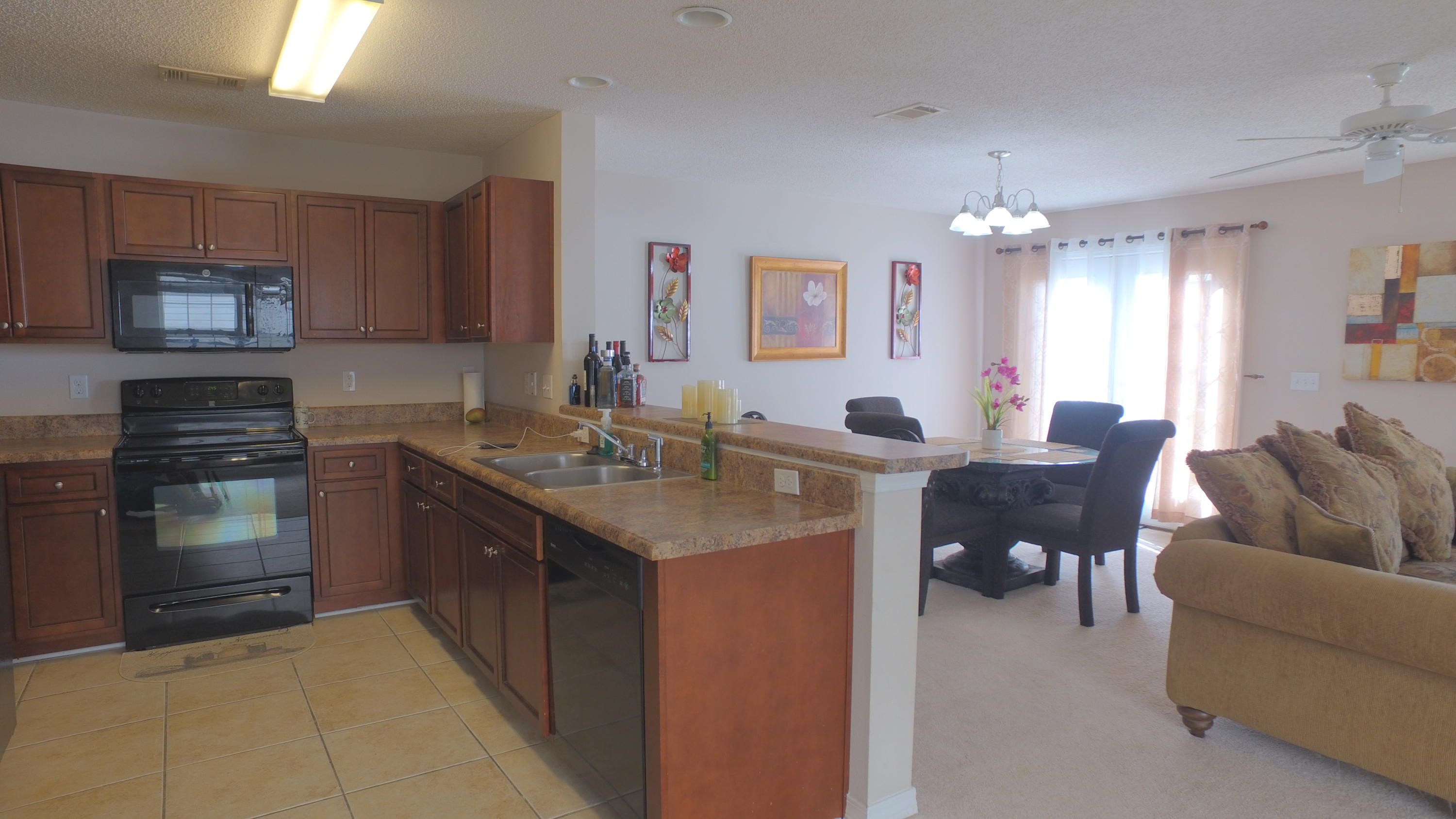 303 Dahlquist Drive Crestview, FL 32539 - Photo 2 of 15 a kitchen with a refrigerator stove and sink