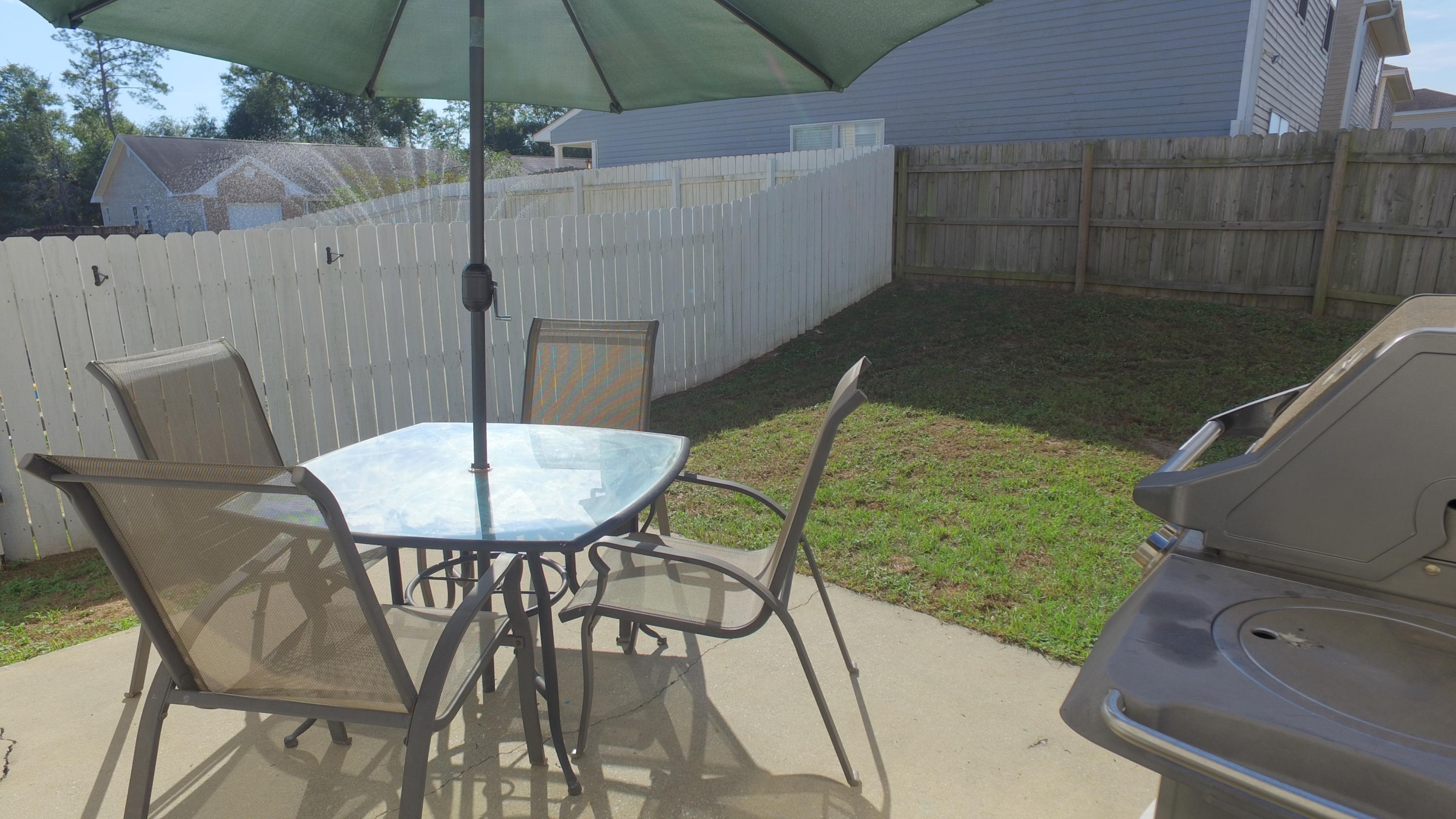 303 Dahlquist Drive Crestview, FL 32539 - Photo 13 of 15 a backyard of a house with table and chairs