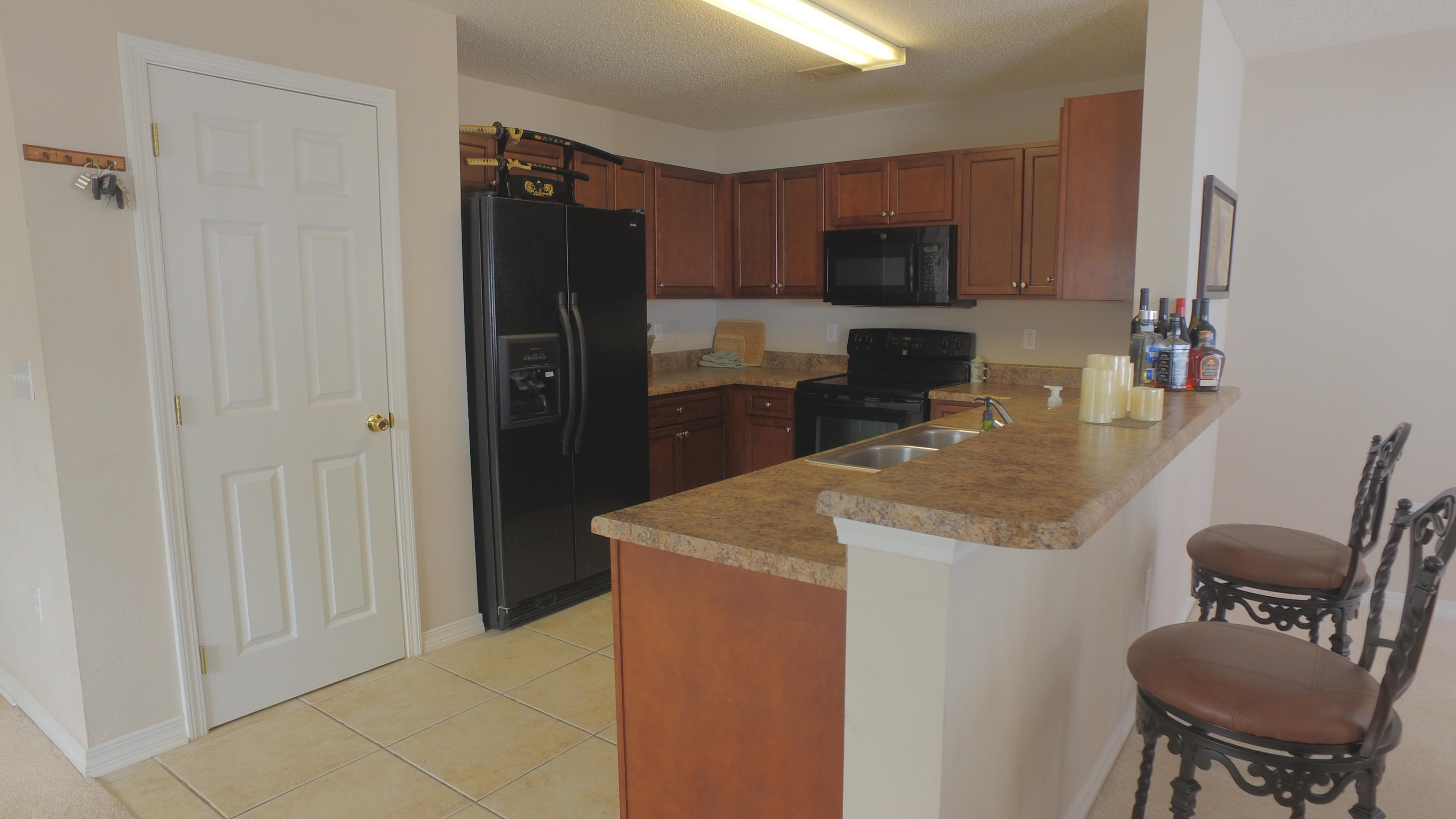 303 Dahlquist Drive Crestview, FL 32539 - Photo 4 of 15 a kitchen with stainless steel appliances granite countertop a refrigerator and a stove top oven
