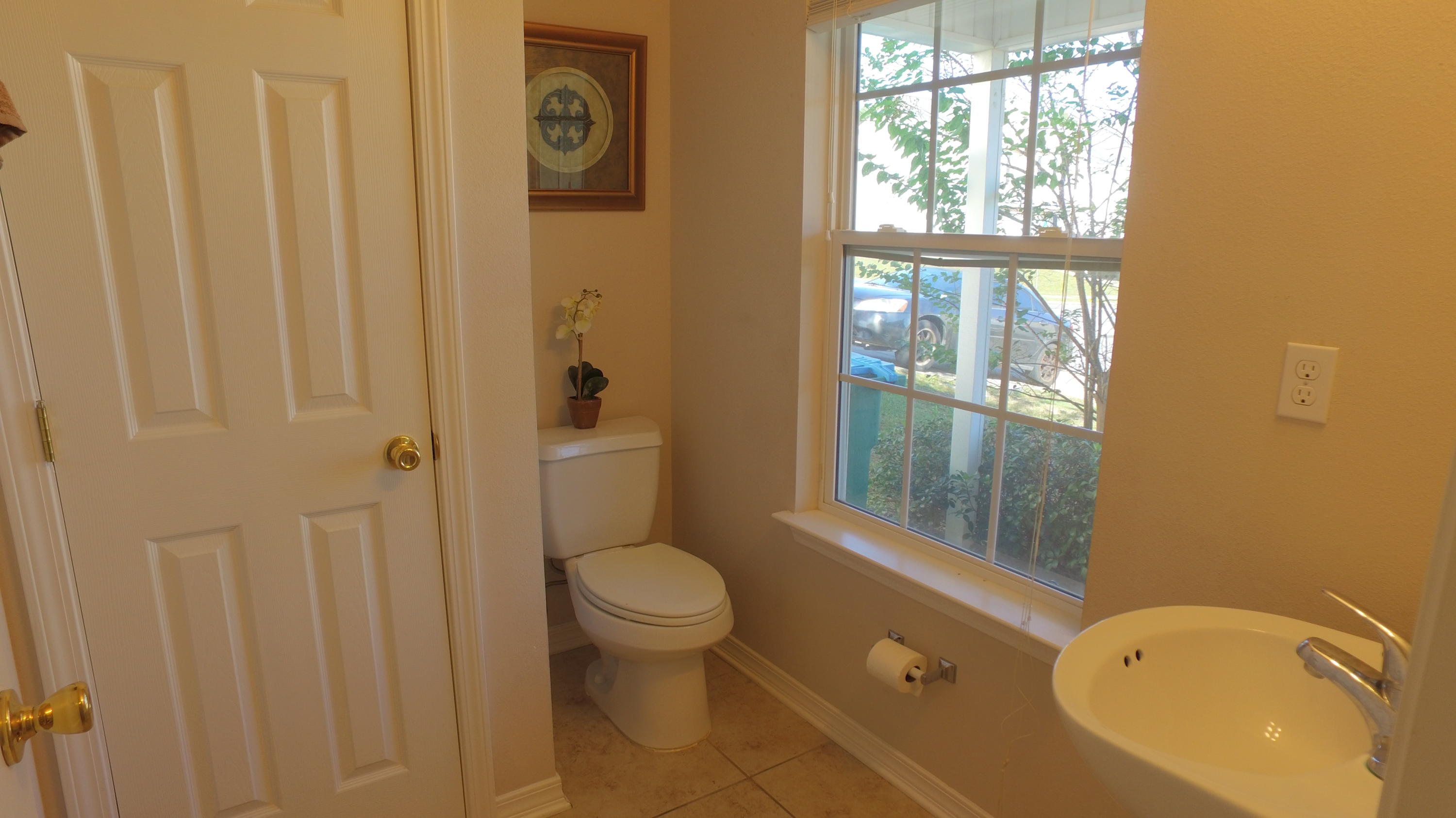 303 Dahlquist Drive Crestview, FL 32539 - Photo 6 of 15 a bathroom with a sink toilet and shower