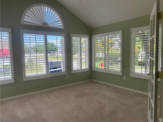 2043 Abbey View Road West Jordan, UT 84088 - Photo 6 of 15 Vaulted ceiling room featuring multiple windows with plantation shutters, including a half-round window