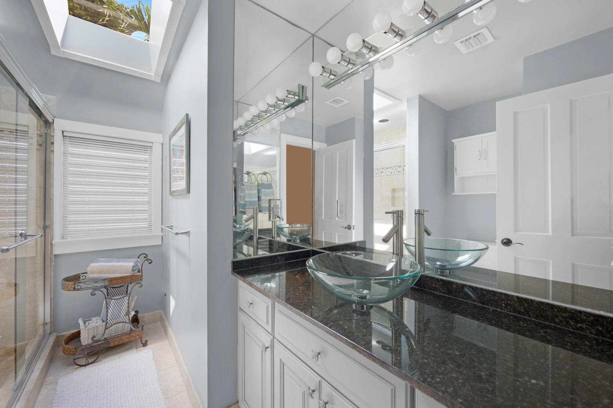 606 Truman Avenue, Unit 10 Key West, FL 33040 - Photo 13 of 20 a bathroom with a granite countertop sink and a mirror