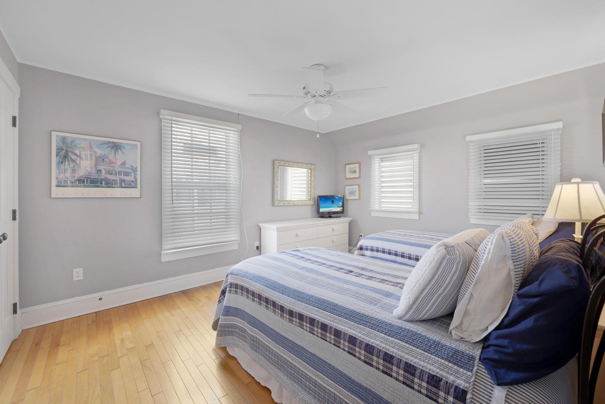 606 Truman Avenue, Unit 10 Key West, FL 33040 - Photo 15 of 20 a bedroom with a bed and wooden floor