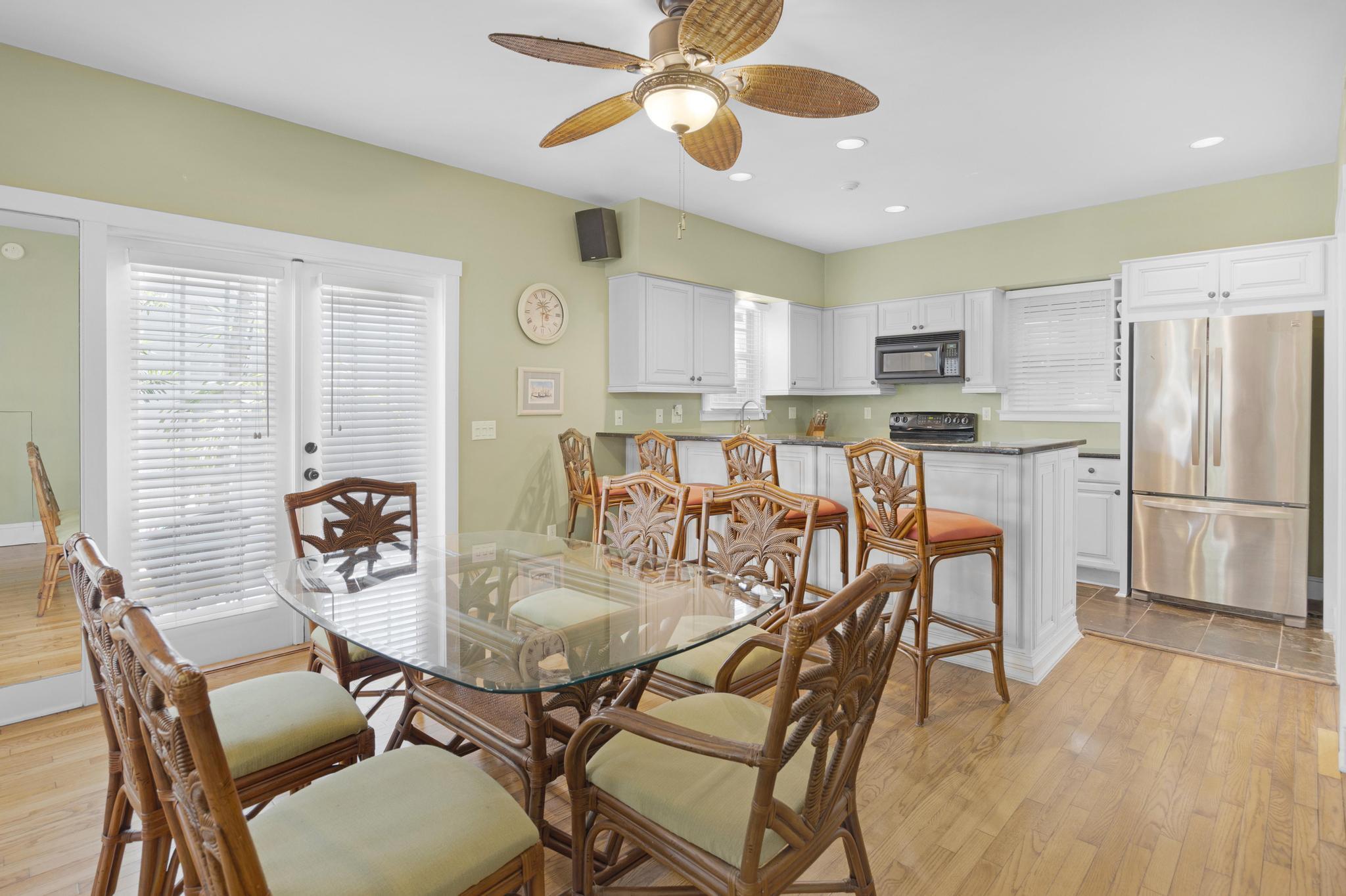 606 Truman Avenue, Unit 10 Key West, FL 33040 - Photo 6 of 20 a dining room with stainless steel appliances a table chairs and chandelier