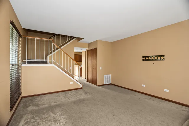 a view of an empty room with stairs