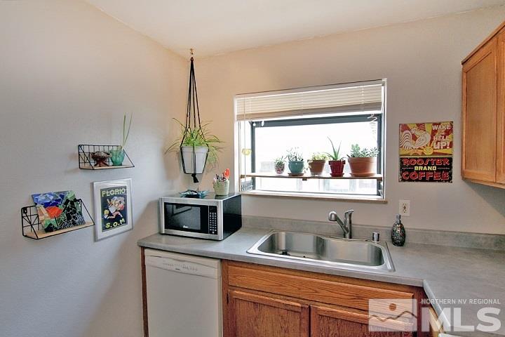4985 West 7th Street, Unit 10 Reno, NV 89503 - Photo 3 of 20 a kitchen with a refrigerator and a sink