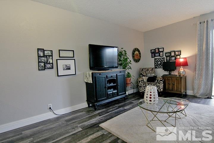 4985 West 7th Street, Unit 10 Reno, NV 89503 - Photo 8 of 20 a living room with furniture a flat screen tv and a fireplace