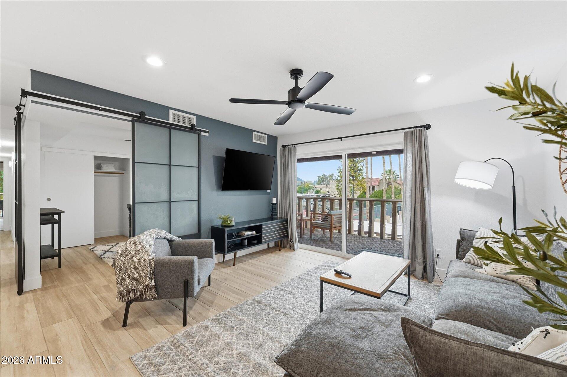 8649 East Royal Palm Road, Unit 239 Scottsdale, AZ 85258 - Photo 13 of 34 a living room with furniture and a flat screen tv