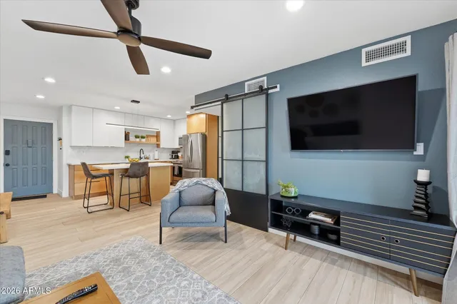 a view of a chairs and table in patio with a grill