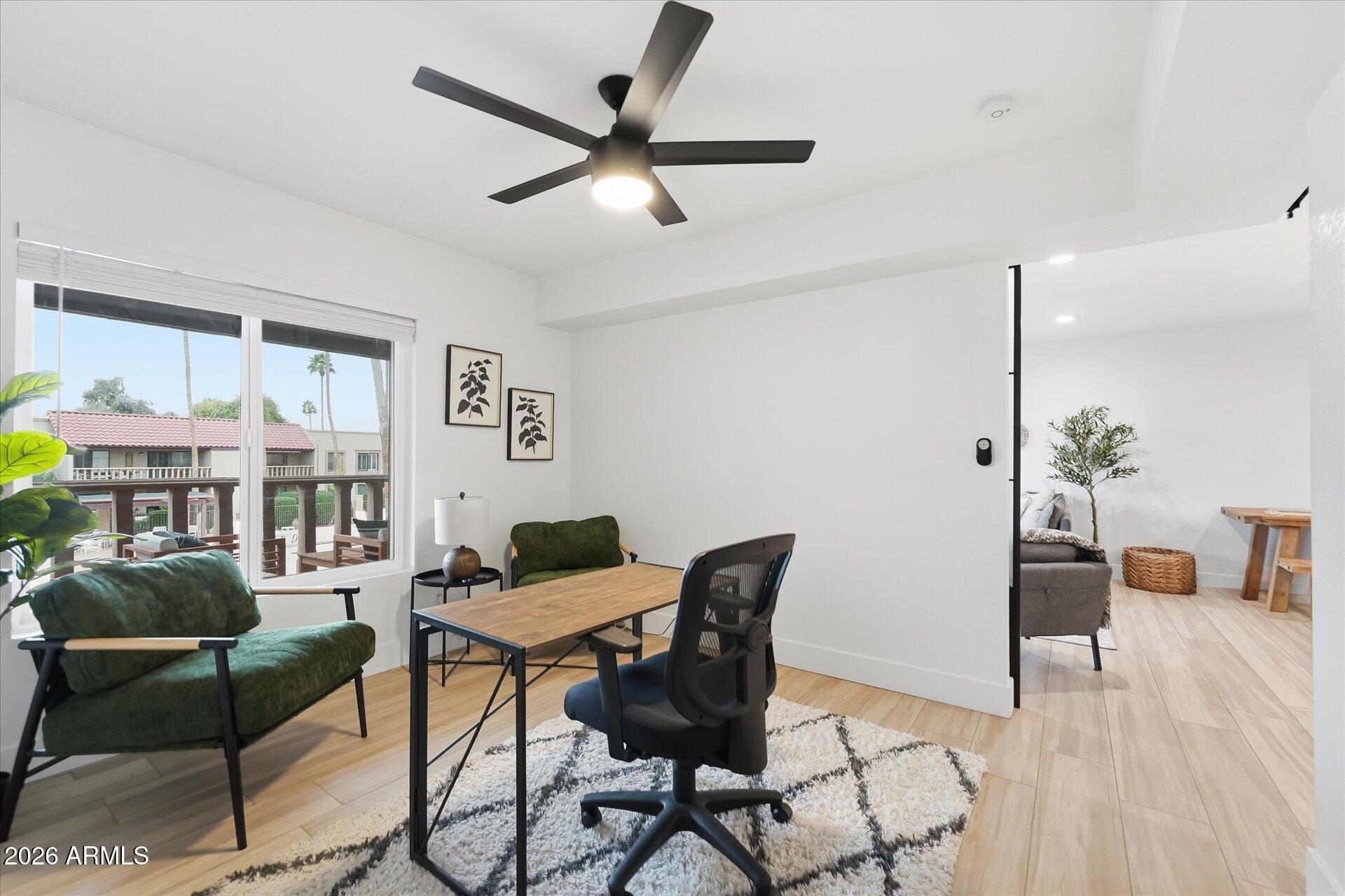 8649 East Royal Palm Road, Unit 239 Scottsdale, AZ 85258 - Photo 19 of 34 a living room with furniture and a wooden floor