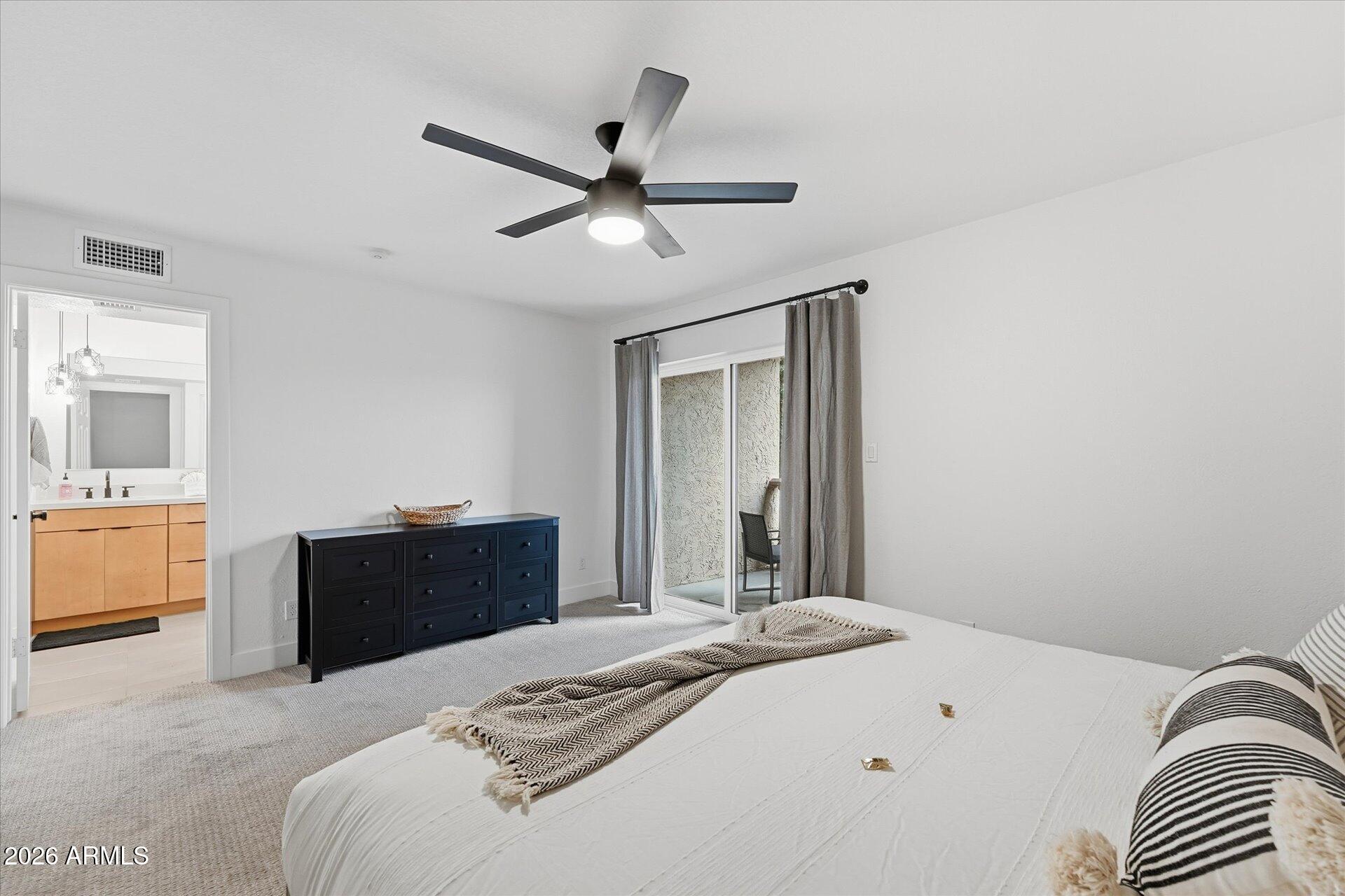 8649 East Royal Palm Road, Unit 239 Scottsdale, AZ 85258 - Photo 21 of 34 a bedroom with a bed and a dresser