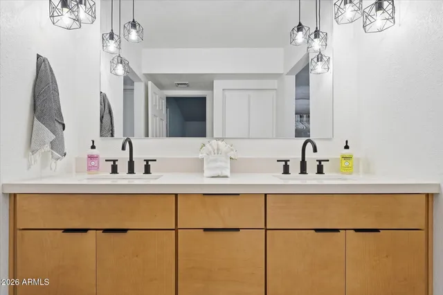 a bathroom with a sink double vanity and a toilet