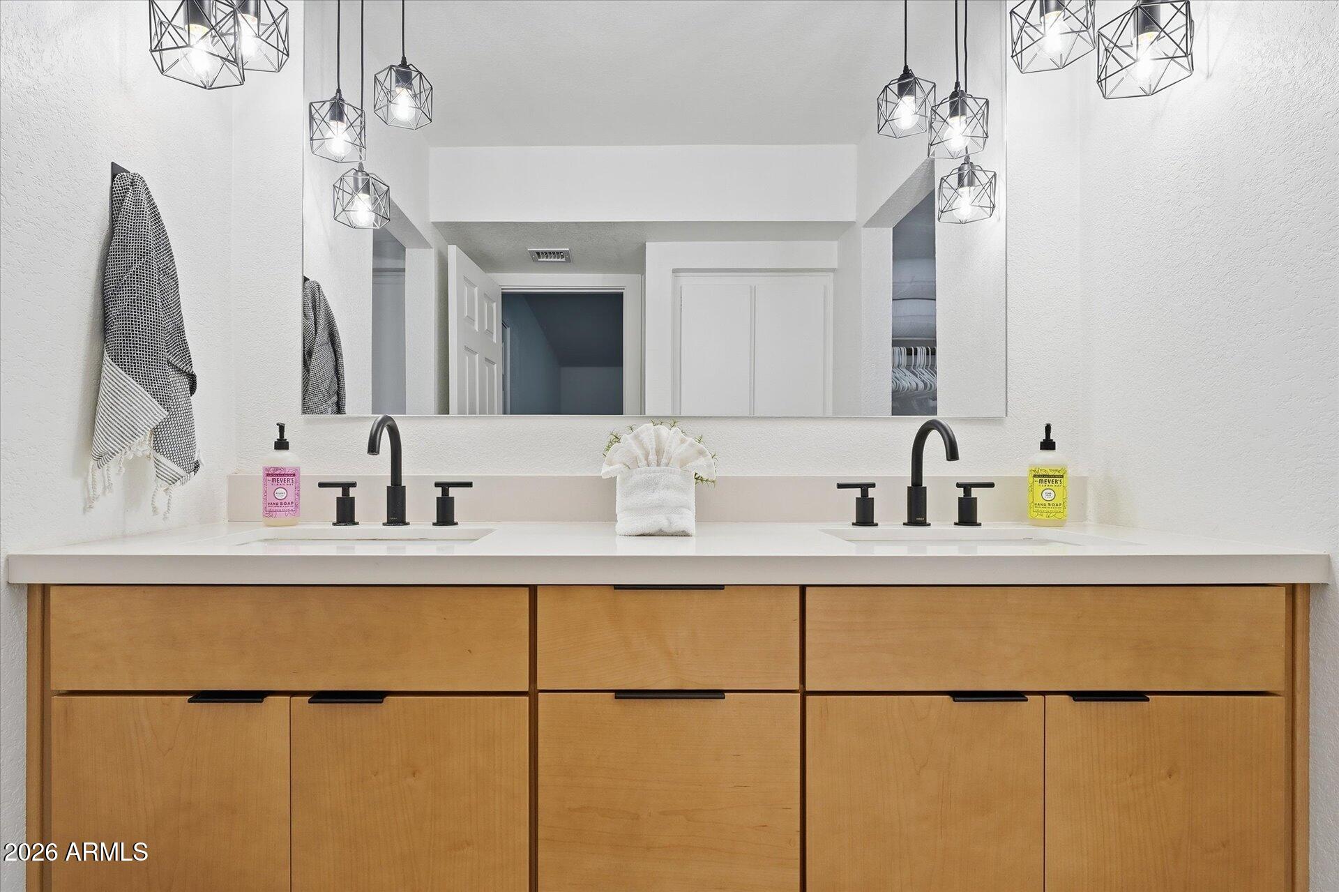 8649 East Royal Palm Road, Unit 239 Scottsdale, AZ 85258 - Photo 22 of 34 a bathroom with a sink and a mirror