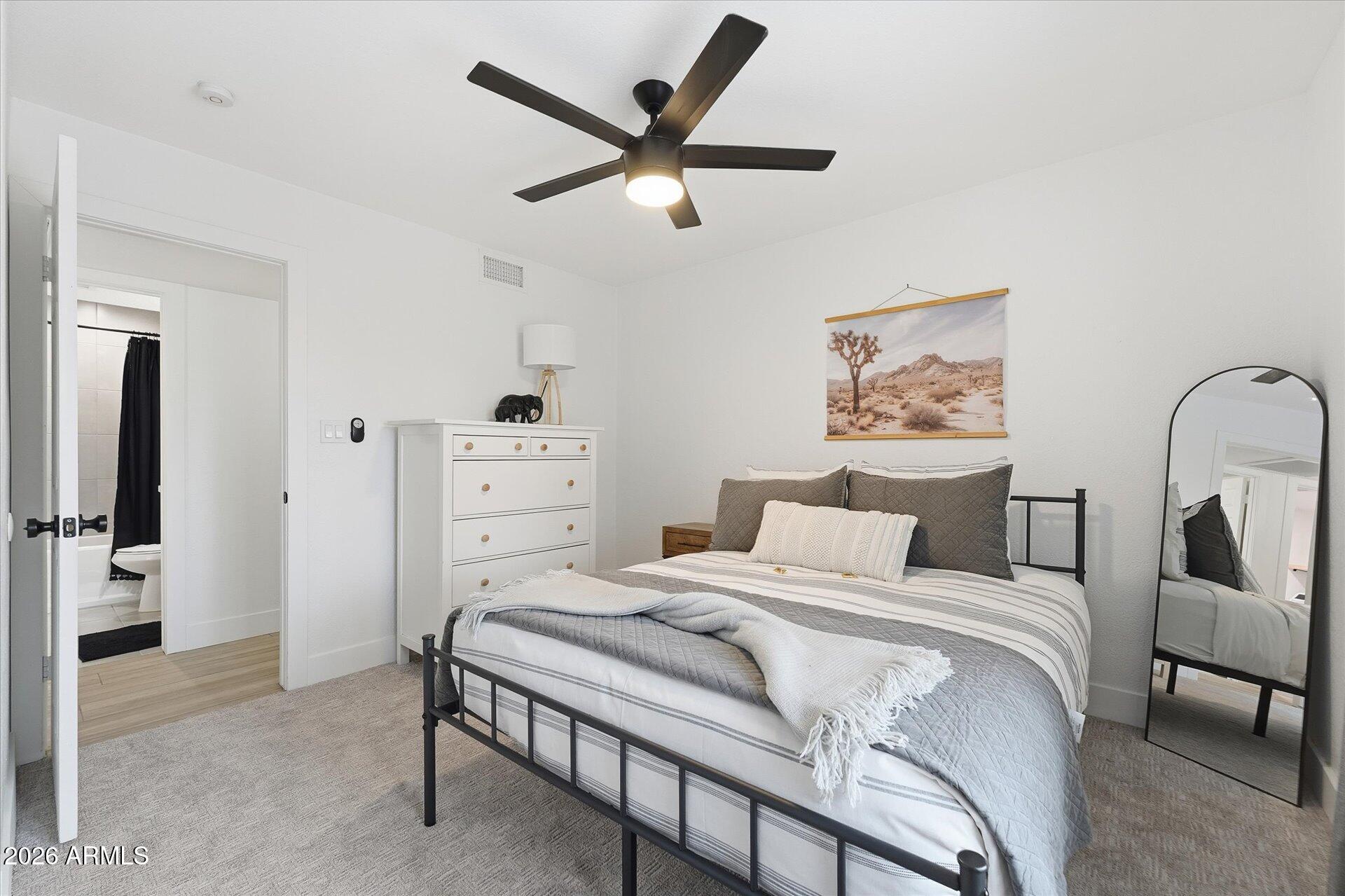 8649 East Royal Palm Road, Unit 239 Scottsdale, AZ 85258 - Photo 29 of 34 a bedroom with a bed and a chandelier