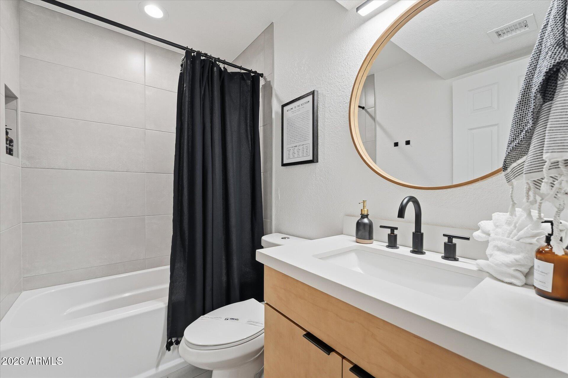 8649 East Royal Palm Road, Unit 239 Scottsdale, AZ 85258 - Photo 30 of 34 a bathroom with a sink a toilet and shower