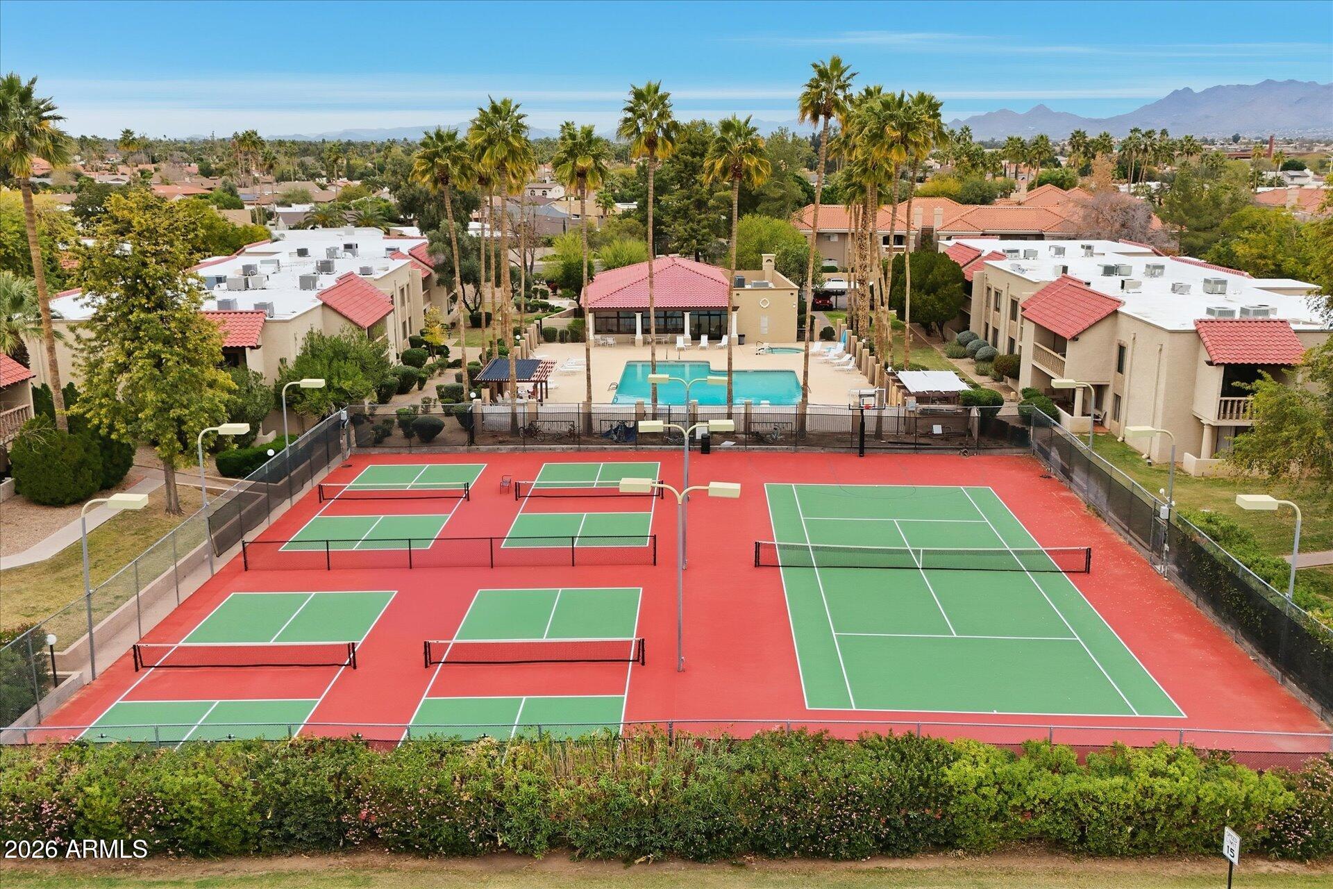 8649 East Royal Palm Road, Unit 239 Scottsdale, AZ 85258 - Photo 32 of 34 a building view with swimming pool and lawn chairs