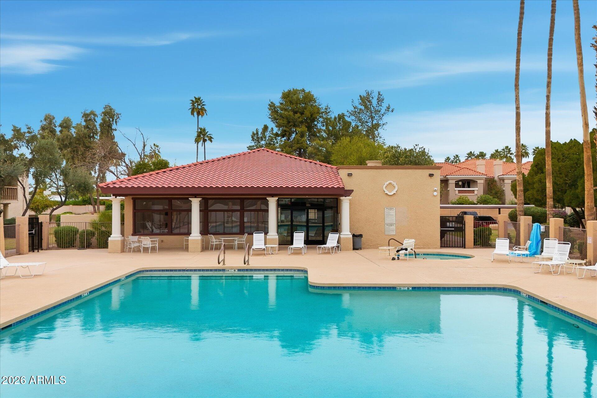 8649 East Royal Palm Road, Unit 239 Scottsdale, AZ 85258 - Photo 34 of 34 a front view of a house with a yard table and chairs