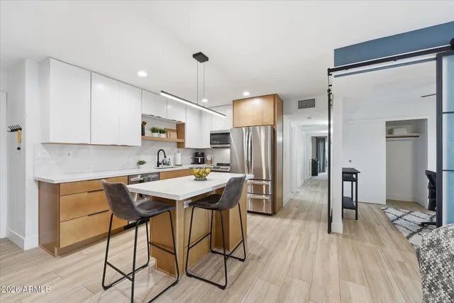a kitchen with a sink cabinets and wooden floor