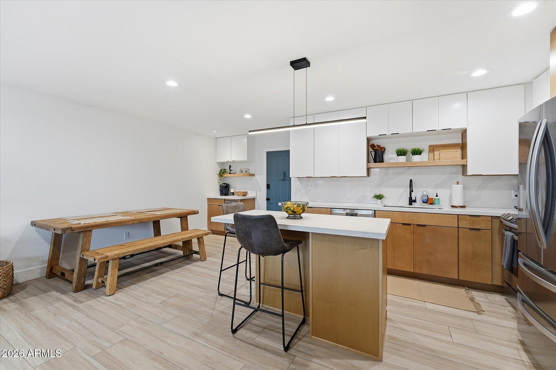 8649 East Royal Palm Road, Unit 239 Scottsdale, AZ 85258 - Photo 7 of 34 a kitchen with a sink cabinets and wooden floor