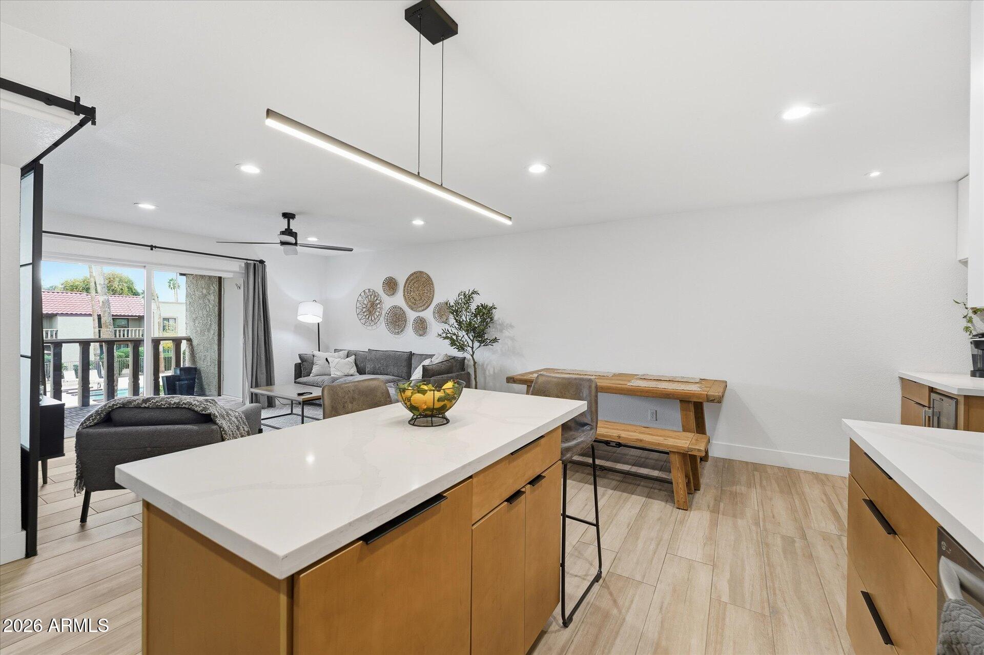 8649 East Royal Palm Road, Unit 239 Scottsdale, AZ 85258 - Photo 9 of 34 a view of a dining room with furniture and wooden floor