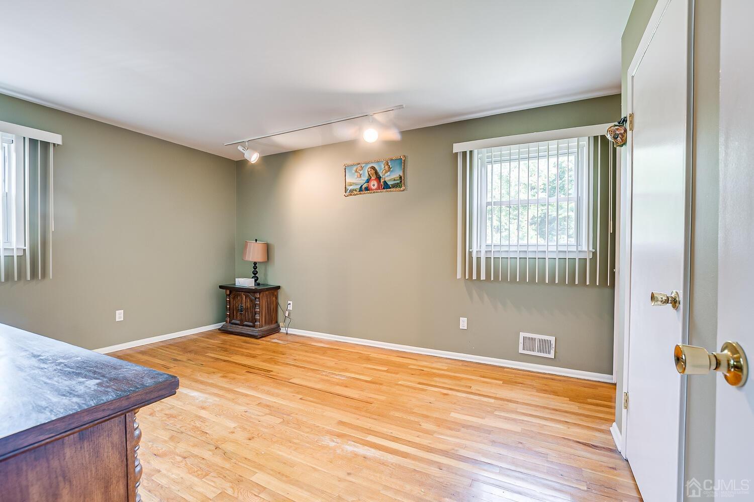 2 Julie Drive Edison, NJ 08820 - Photo 19 of 34 a view of a livingroom with wooden floor and a bathroom