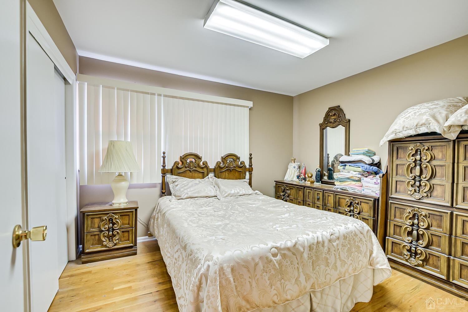 2 Julie Drive Edison, NJ 08820 - Photo 22 of 34 a bedroom with a bed and wooden floor