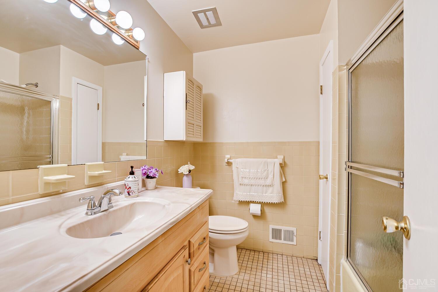 2 Julie Drive Edison, NJ 08820 - Photo 25 of 34 a bathroom with a sink toilet vanity and shower